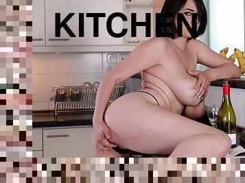 Beautiful brunette with big tits masturbates in the kitchen