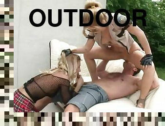 Horny blondes have a threesome outdoors with a big cock