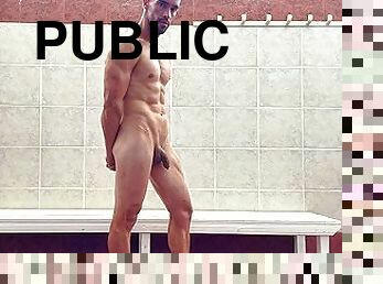 Fit stud naked in public locker room flexing muscles after gym training