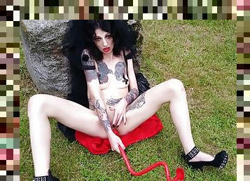 Blasphemic satanic whore fucking her pussy and ass in an old cemetary
