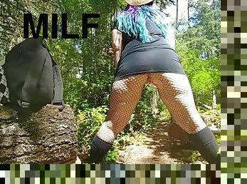 Blue haired Milf in fishnets pissing on public trail