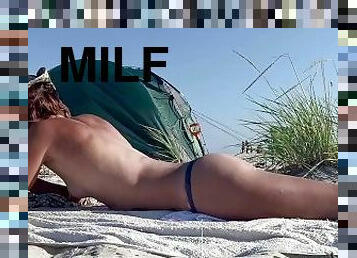 Sexy MILF tanning topless