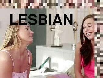 Beautiful young lesbians lick and finger each others pussies in a threesome