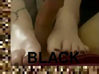 Black toes stroke his cock