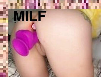 Miss Coxxx grips a dildo while wearing a light up butt plug