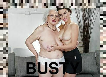 Smiley brunette Tiffany Doll pleasures busty granny on the sofa