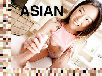 Smiley Asian girl pleasures her man in the living room