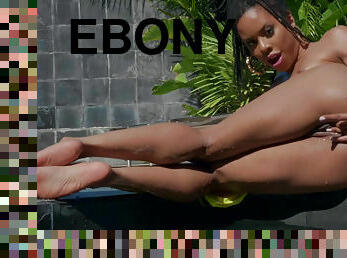 WIld ebony girl Kira Noir stimulates her holes near the pool