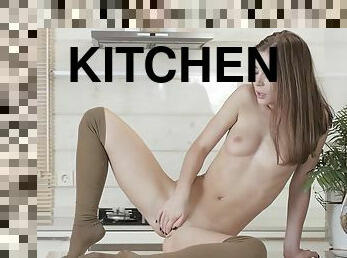 Teen Lili caresses her body and fingers herself on the kitchen counter