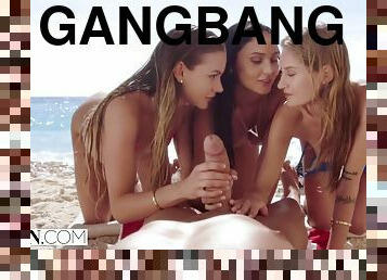 Slutty teens share huge dick on the beach