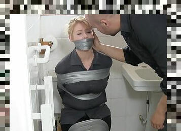 A hot MILF gets bound with duct tape in the toilet. Full video.