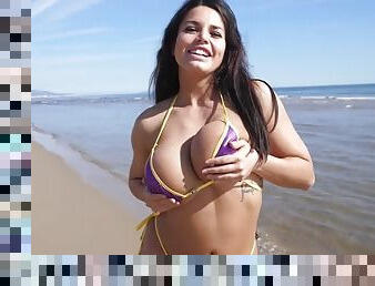 Busty bikini model enjoys the beach