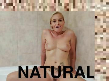 Tattooed blonde with big natural tits relaxing in warm bathtub solo