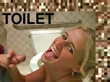 Pigtailed blonde wanking cock in the toilet