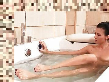 Beauty rubs her feet and legs in bathtub