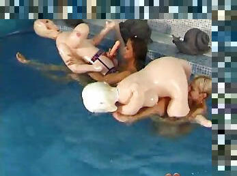 Two lesbian teens play with some blow up dolls in the pool