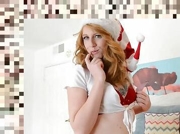 Redhead gal in miss Santa suit masturbates