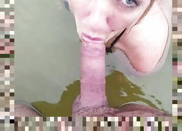 Blowjob from a mermaid in the water in the rain in front of people