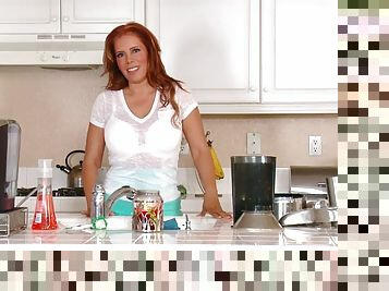 Redhead milf strokes her pussy in the middle of the kitchen